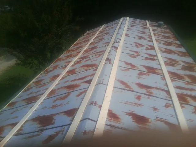 Rusted metal roof panels with new wood purlins before replacement — Storm Damage Roof Repair in Callensburg by Roofing Brothers